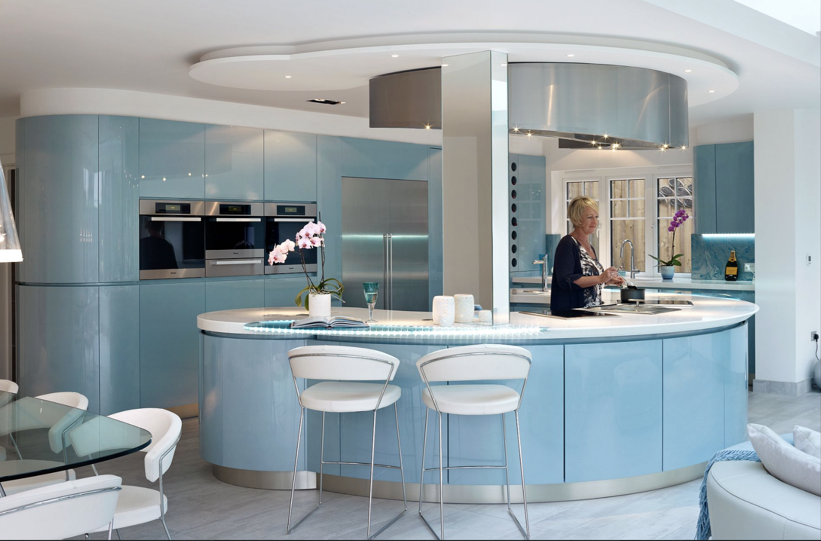 Italian kitchen with glossy light blue curved cabinets